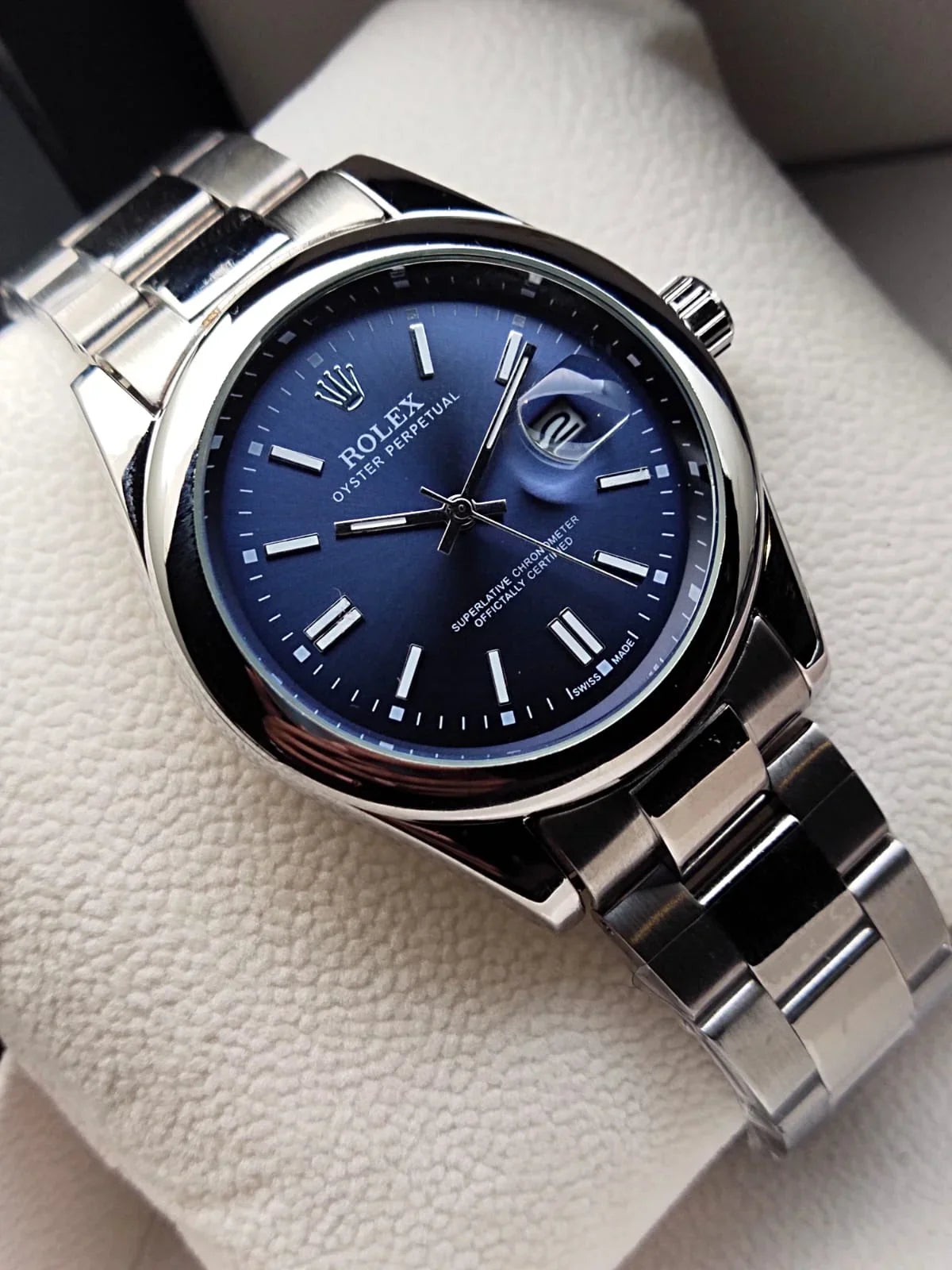 Rolex Oyster Perpetual Date 34mm (Reference: 115200) with a blue sunburst dial.