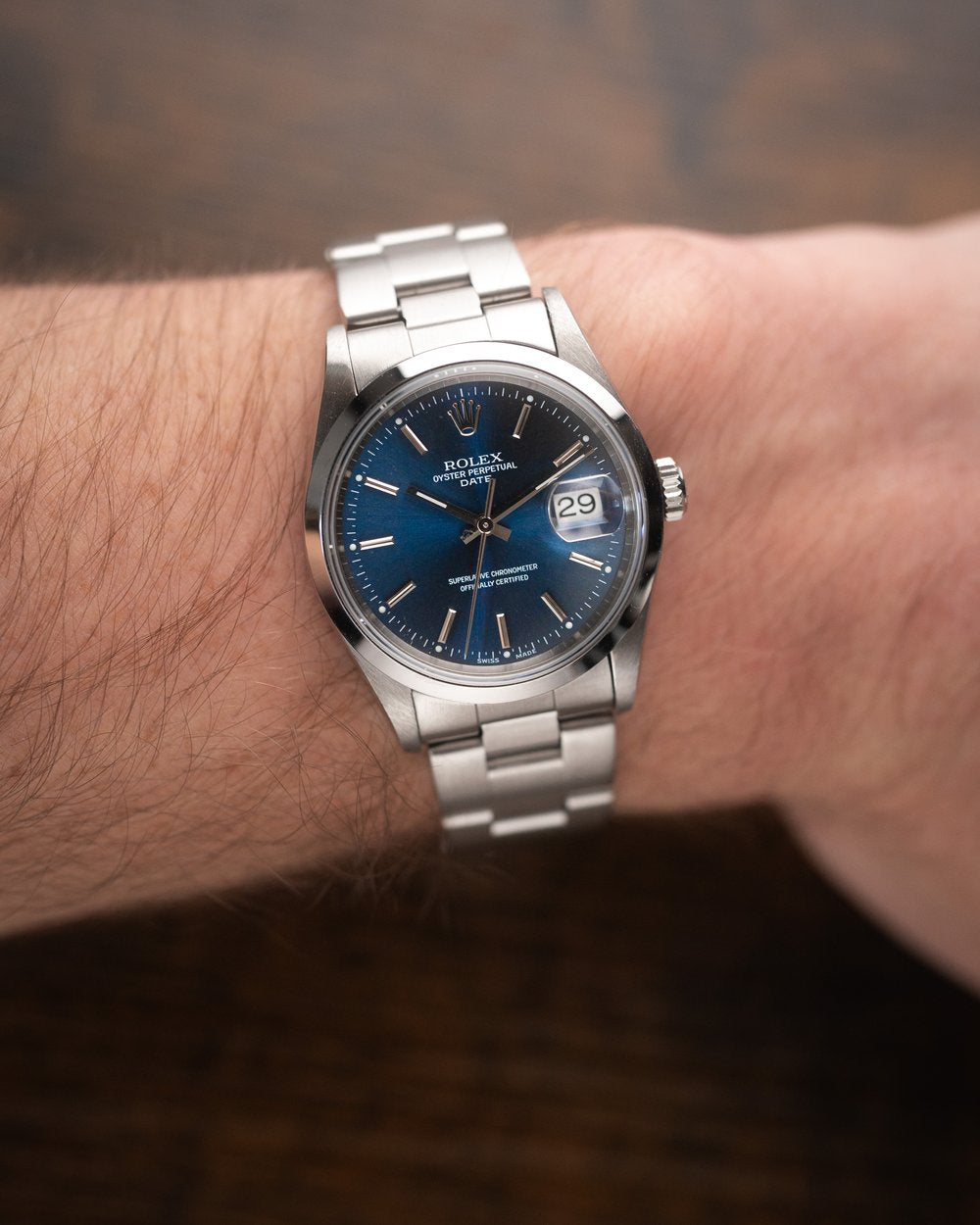 Rolex Oyster Perpetual Date 34mm (Reference: 115200) with a blue sunburst dial.
